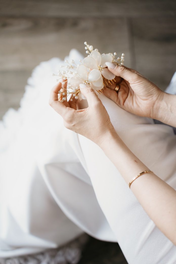Bride holding a delicate floral hair accessory
