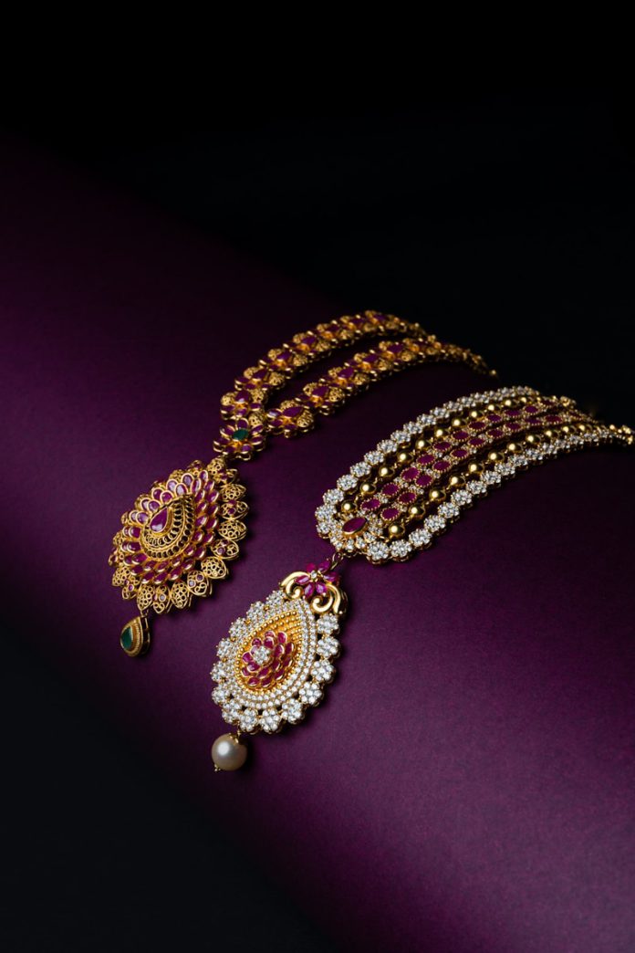 A bunch of jewelry on a purple surface